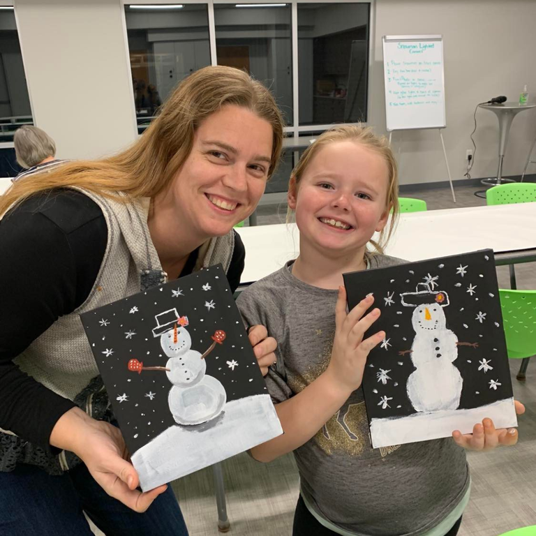 mother and daughter holding snowman lighted canvas paintings