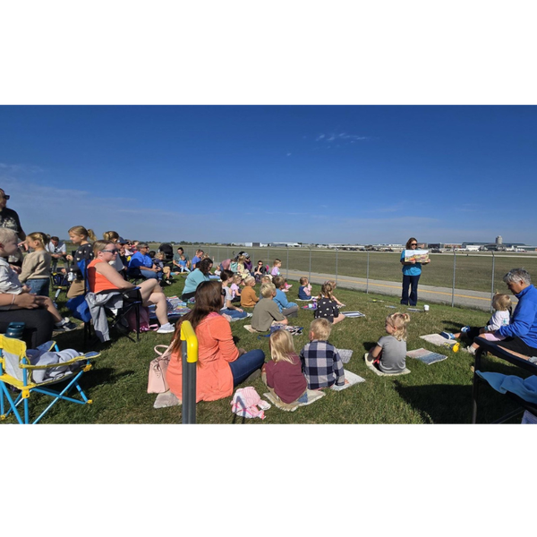 a group of people gathered at the airport for storytime