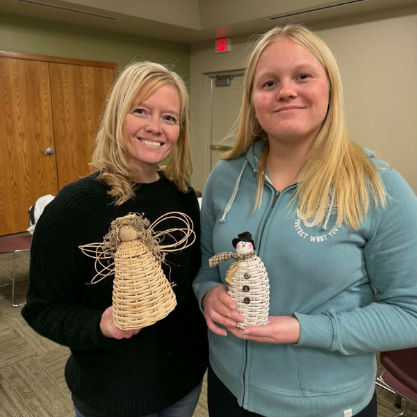 Two people holding baskets