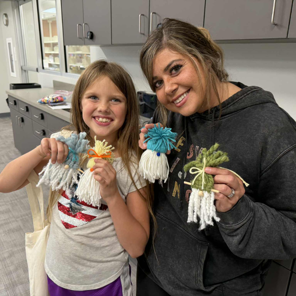 Mother and child holding gnome crafts