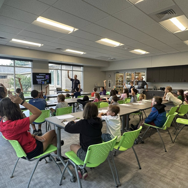 children sitting at tables participating in Science Camp